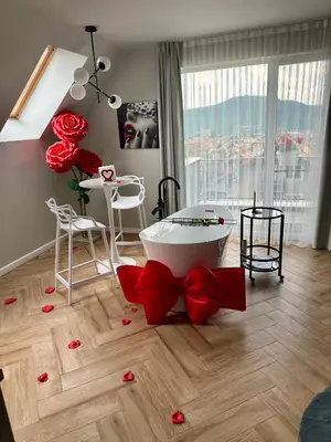 a living room with a bath tub with red bows at Студио с вана и гледка в 
