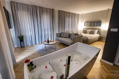 a living room with a bath tub in the middle of a room at Студио с вана и гледка в 