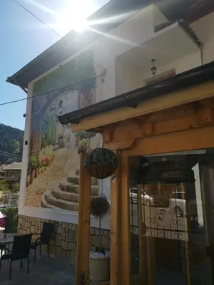 a mural on the side of a building at Къща Томови,стаи за гости in Devin