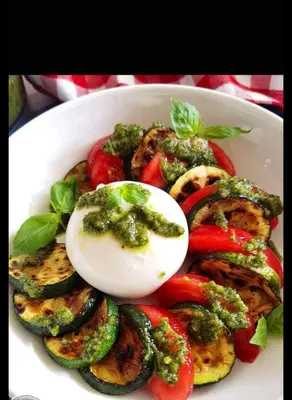 a white bowl of vegetables with an egg on top at Къща Томови,стаи за гости in Devin