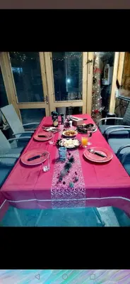 a table with a pink table cloth on top at Къща Томови,стаи за гости in Devin