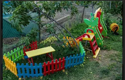 a toy garden with a bench and a playground at Sunshine villa Dzhigurovo in Sandanski