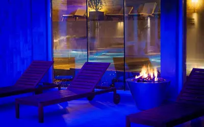 two chairs and a fire pit in a room at Royal Spa Hotel in Velingrad