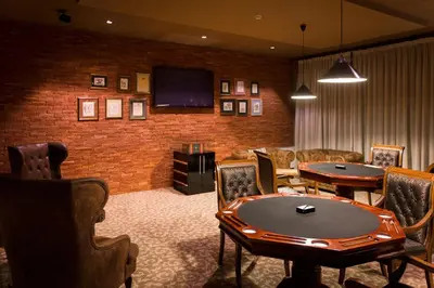 a waiting room with a table and a tv at Royal Spa Hotel in Velingrad