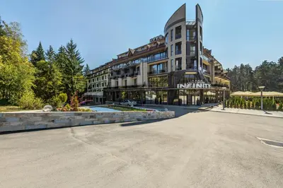 an empty street in front of a large building at Villa Dea & Villa Ina - Villas & SPA Park in Velingrad by Flat Mаnager in Velingrad
