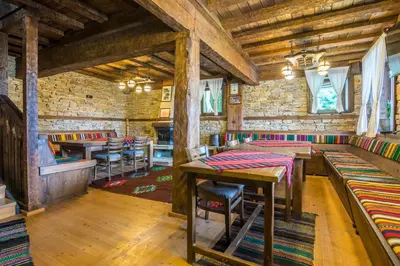 a restaurant with tables and chairs in a room at Къща Стара Македония in Gostun