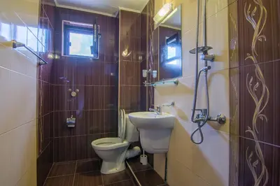 a small bathroom with a toilet and a sink at Къща Стара Македония in Gostun