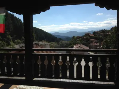 a balcony with a view of the mountains at Къща Стара Македония in Gostun