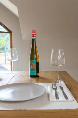 a bottle of wine sitting on a table with a plate at Park Loft next to Eagle's Bridge in Sofia
