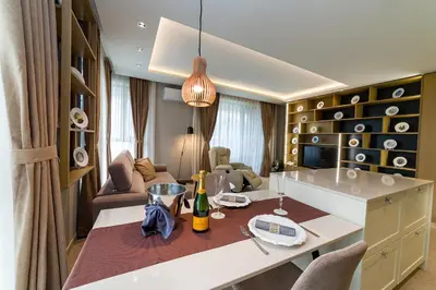 a kitchen and living room with a table and chairs at City Park Inn in Plovdiv