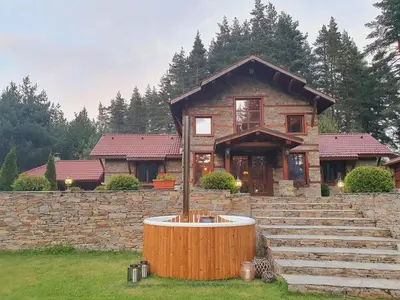 a house with a fountain in front of it at Moiata Kashta Villa in Popovi Livadi