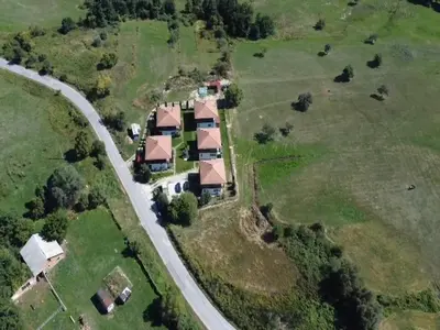 an aerial view of a house with a road at Къща за гости 