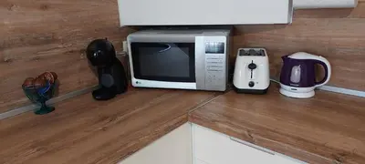 a microwave oven sitting on top of a kitchen counter at Къща за гости 