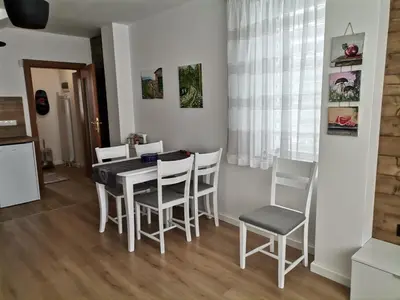 a kitchen and dining room with a table and chairs at Къща за гости 