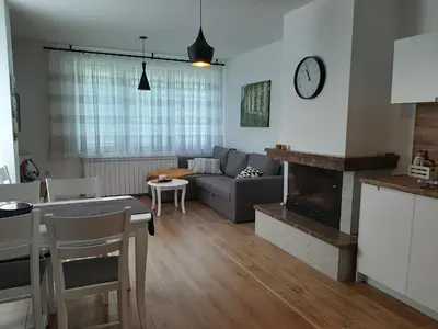 a living room with a couch and a table at Къща за гости 