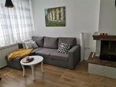 a living room with a couch and a table at Къща за гости 
