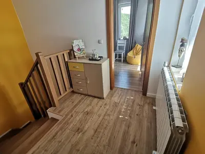 a room with a staircase and a dresser and a hallway at Къща за гости 