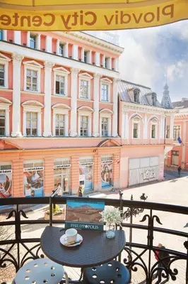 a table and chairs in front of a building at Plovdiv City Center Hotel in Plovdiv