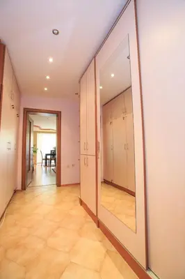 a hallway with a large mirror on the wall at Мария Парк in Sandanski