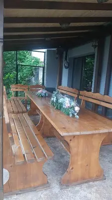 a large wooden table with flowers on top of it at Къща за гости Алекс in Karlovo