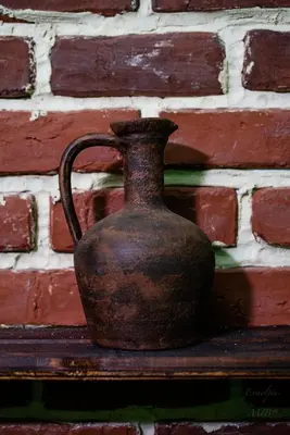 a vase sitting on a shelf next to a brick wall at Art apartment EVMOLPIAS near Roman stadium in Plovdiv