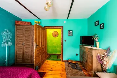 a bedroom with green and blue walls and a door at Art apartment EVMOLPIAS near Roman stadium in Plovdiv