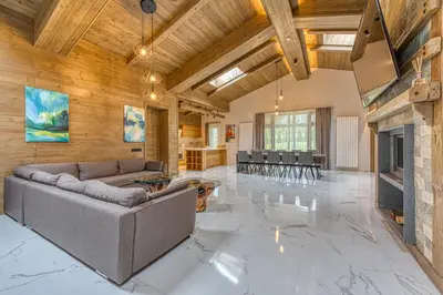 a living room with a couch and a fireplace at Pirin Style Villa & Spa in Bansko