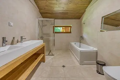 a bathroom with a sink and a tub and a toilet at Pirin Style Villa & Spa in Bansko