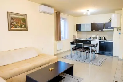a living room with a couch and a table at Villa Kalina Apartments in Bansko