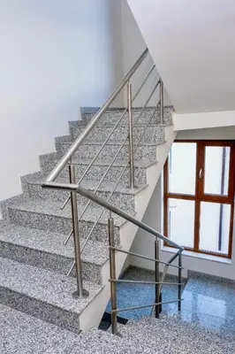a staircase with a metal handrail and a window at Villa Kalina Apartments in Bansko