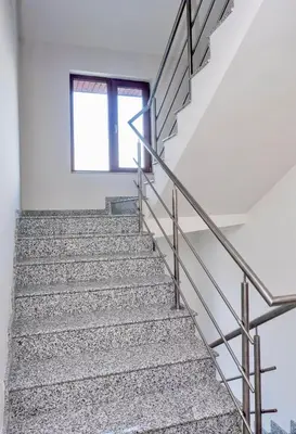 a staircase with metal railings and a window at Villa Kalina Apartments in Bansko