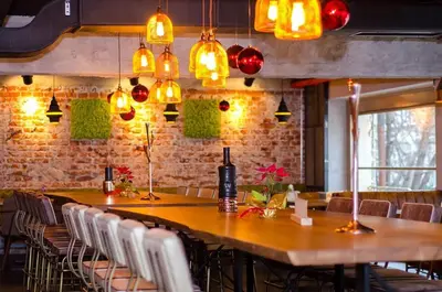 a dining room with a table and chairs and lights at Landmark Apartment in Sofia