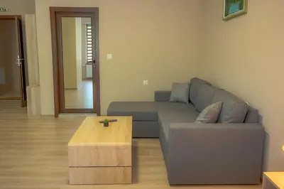 a living room with a couch and a coffee table at Вила Влахов in Sapareva Banya