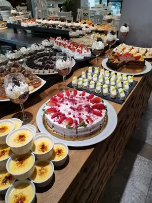 a table with many different types of cakes and desserts at The Five Elements Hotel and SPA in Sapareva Banya