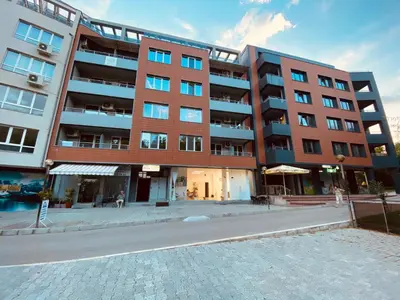 a large brick building on a city street at Irina Apartment in Sandanski