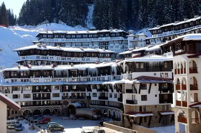 a group of buildings with snow on their roofs at Grand Monastery Private Apartment in Pamporovo