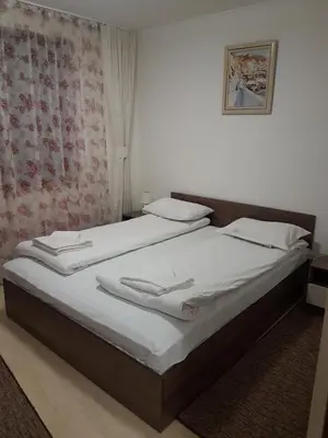 two twin beds in a room with a picture on the wall at Grand Monastery Private Apartment in Pamporovo