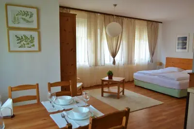 a living room with a table and a bed at Cozy studio in 