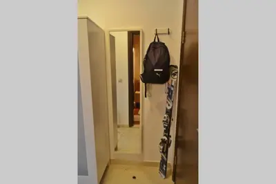 a hallway leading into a room with a mirror at Cozy studio in 