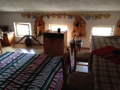 a living room with two beds and two guitars at Katya Guest House in Smolyan