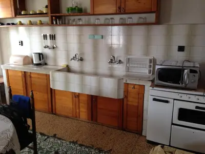 a kitchen with a sink and a microwave at Katya Guest House in Smolyan