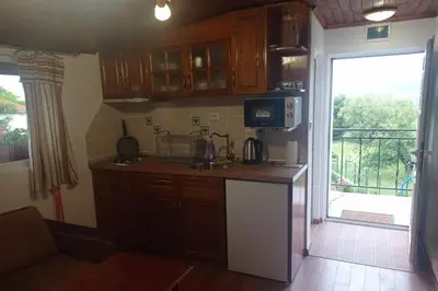 a kitchen with a counter with a microwave and a window at Семейна къща Лазарови in Sapareva Banya