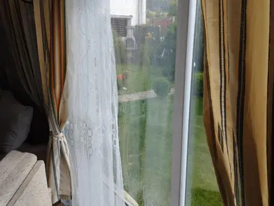 a window with a view of a yard at Семейна къща Лазарови in Sapareva Banya