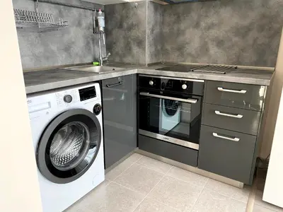 a kitchen with a washing machine and a sink at Mountain View Magenta White apartment in Sofia
