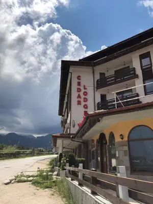 a building on the side of a dirt road at GONDOLAs LODGE in Bansko