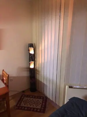 a corner of a room with a door with a rug at GONDOLAs LODGE in Bansko