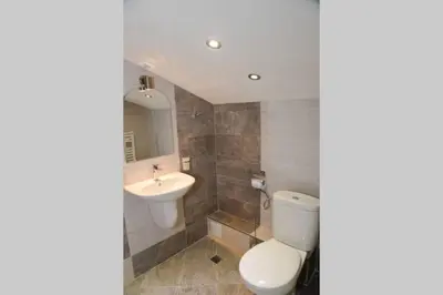 a bathroom with a toilet and a sink at Villa Rila Garden in Beli Iskar