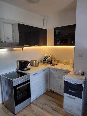 a kitchen with a stove and a sink at Apartment BanskoIN in Bansko