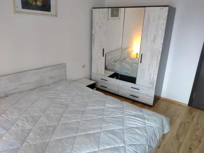 a bedroom with a bed and a large mirror at Apartment BanskoIN in Bansko