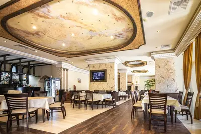 a dining room with tables and chairs and a large painting on the ceiling at BULGARI melnik in Melnik